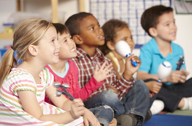 group of elementary age schoolchildren in music class with instruments